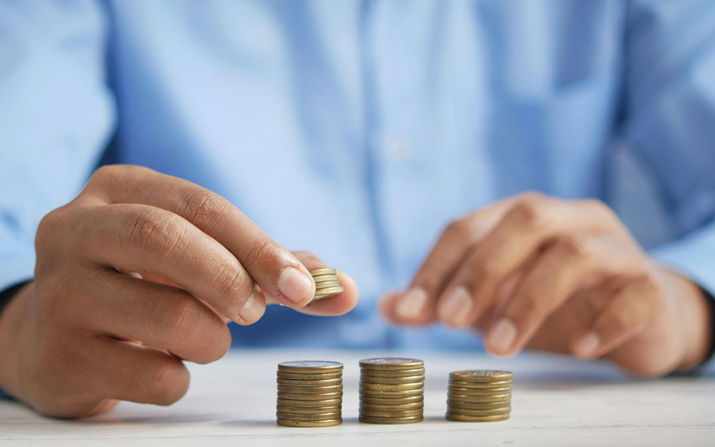 Person stacking coins together